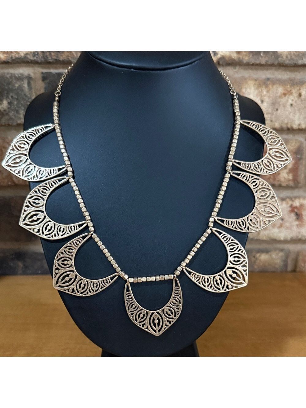 Gold Tone open crescent design statement necklace features